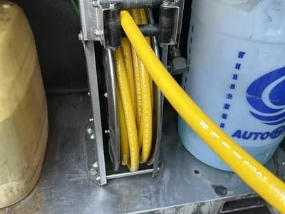 Internal high pressure hose reel fitted inside Nilfisk SH Truck cabinet to protect hose from frost damage.